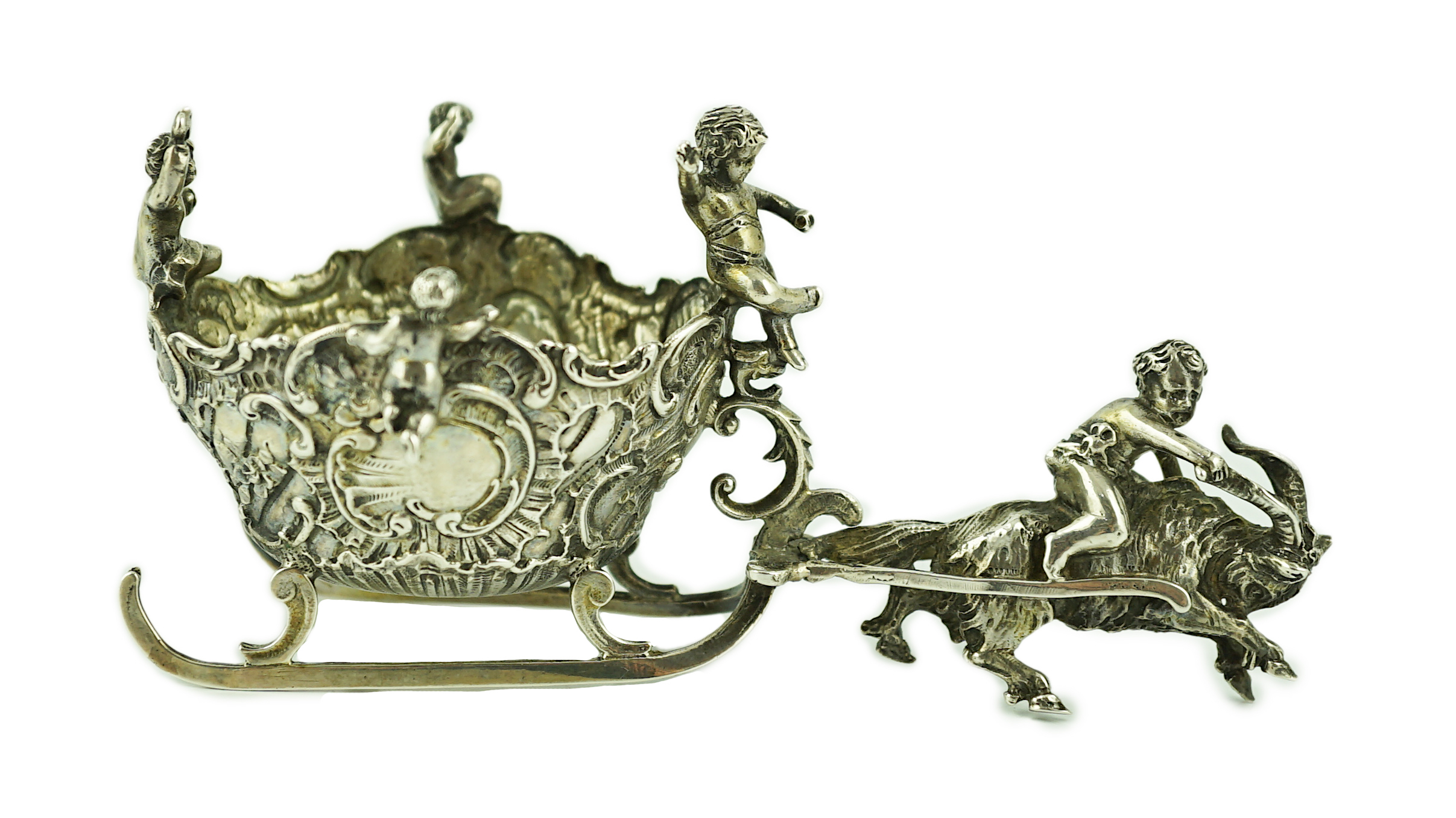 A late 19th century miniature silver model of a sleigh with putti, pulled by a goat, import marks for John George Smith